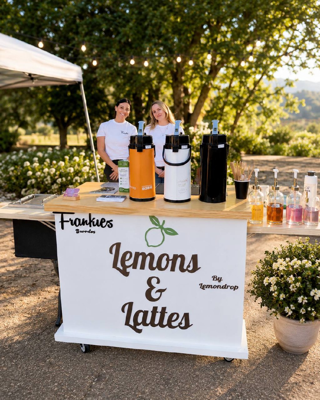 Lemons & Lattes baristas behind the cart at a golden-hour event